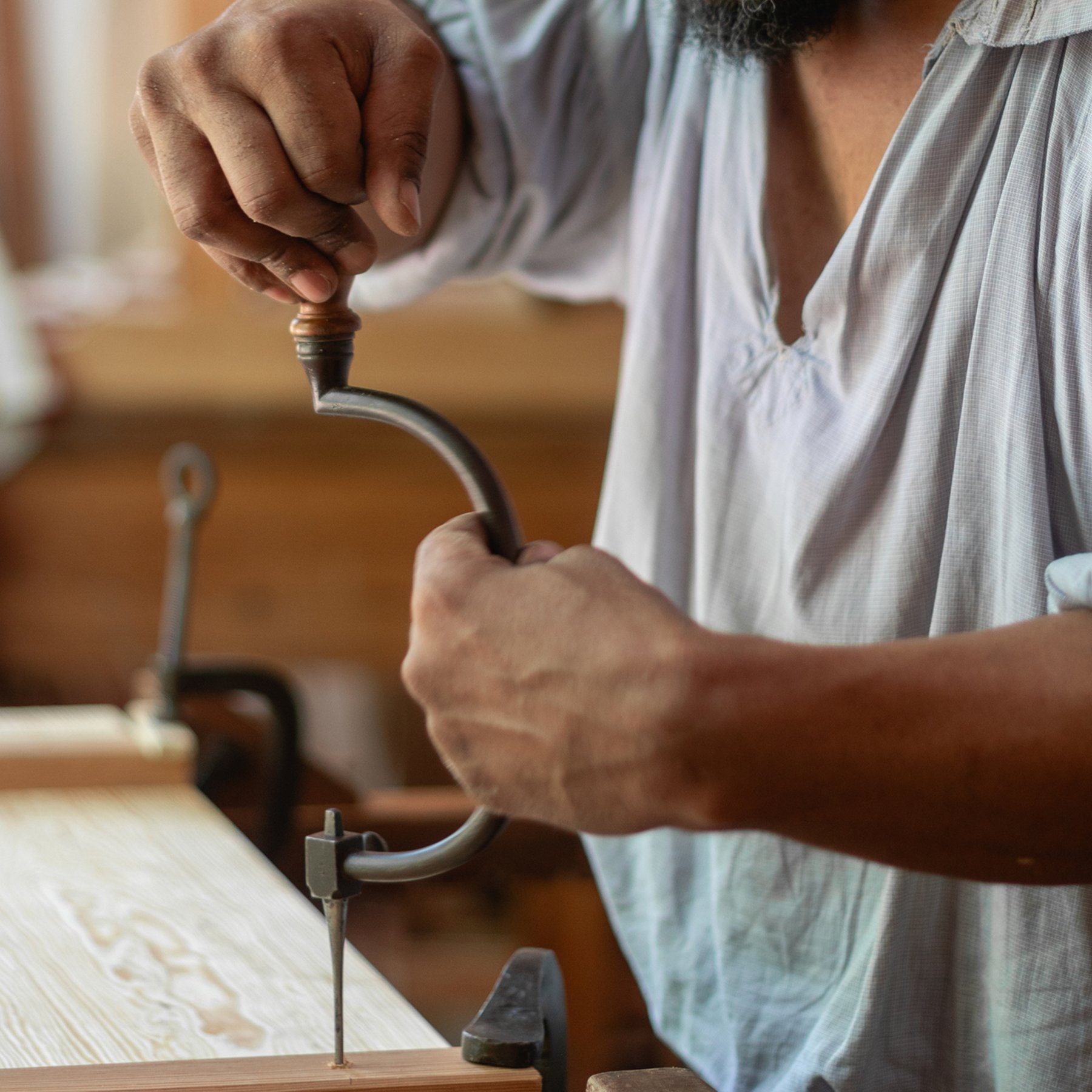 A photo of a joiner helping make a piece of furniture for the Bray School.