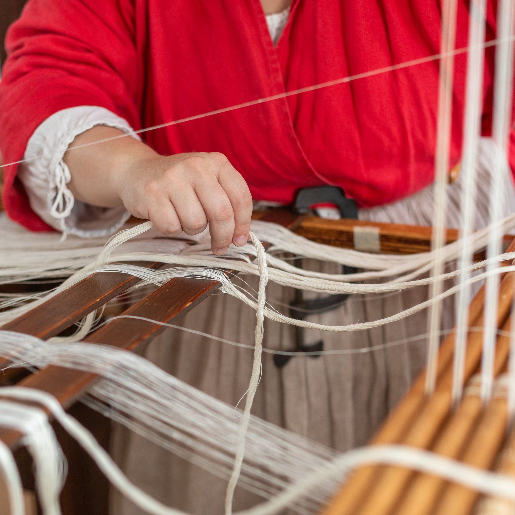 A photo of a weaver weaving textiles for the Bray School.