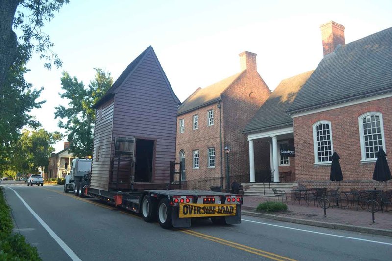 A photo of the windmill being moved on a flatbed truck down Henry Street.