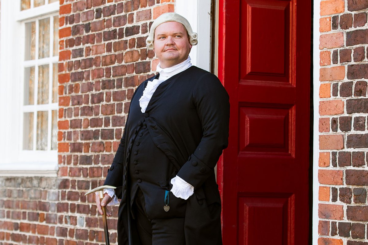 An interpreter dressed as George Wythe faces the camera.