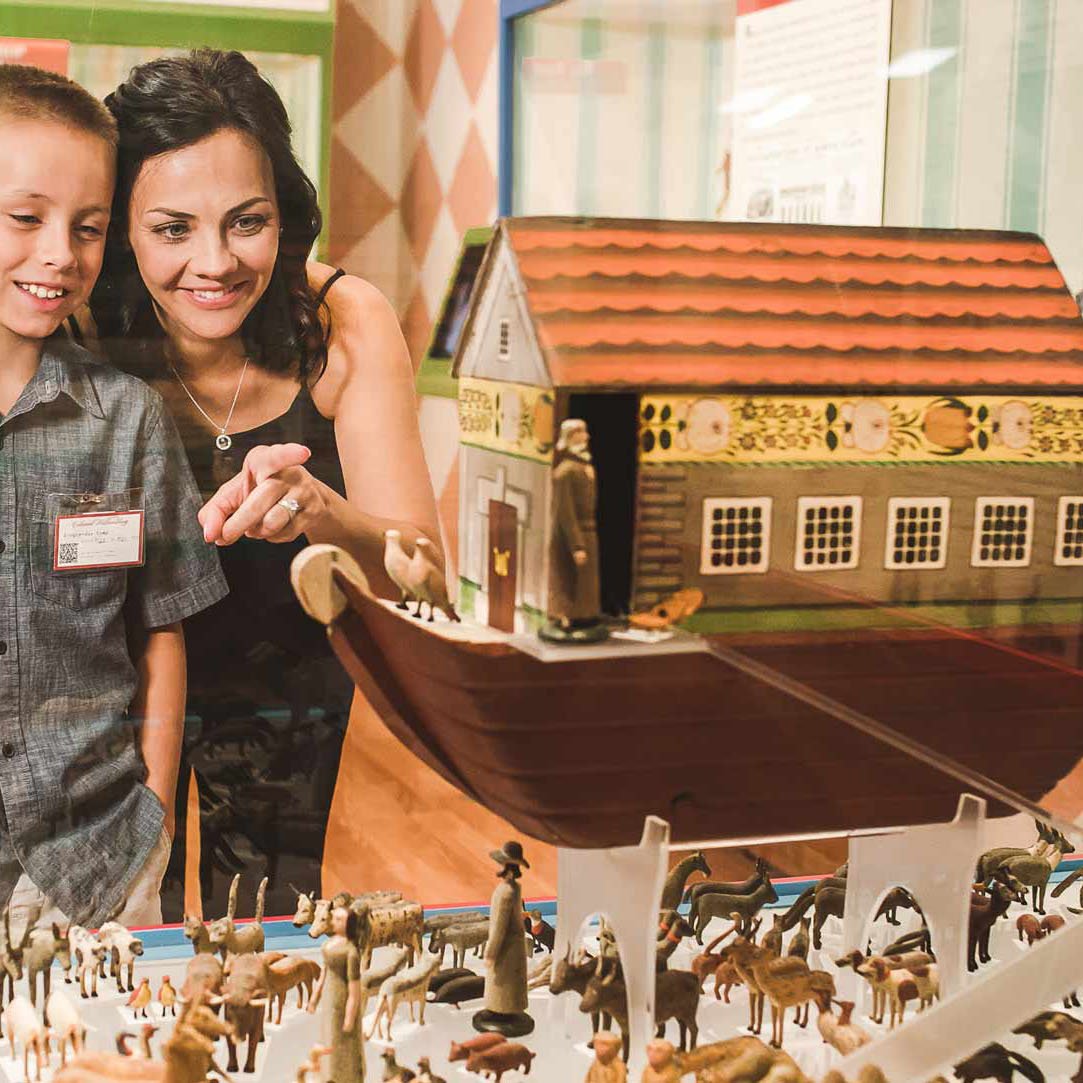 A mom and child look at the Noah's Ark piece in the German Toys in America exhibition.