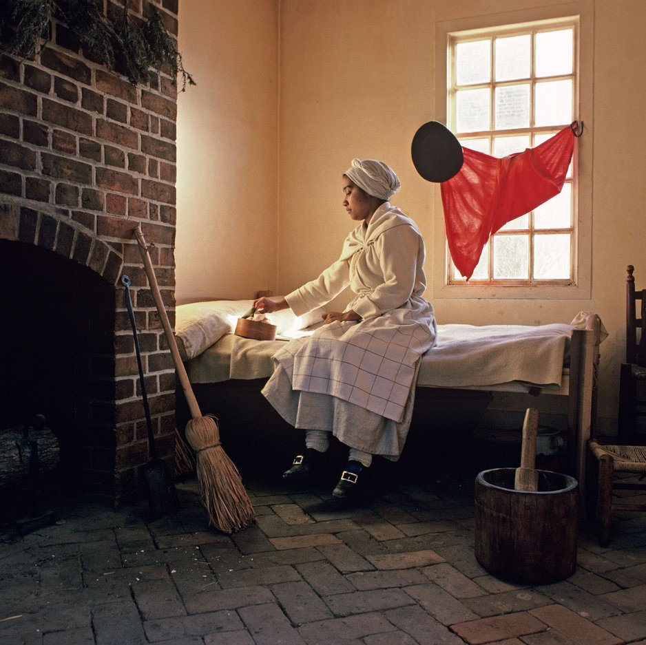 Actor-interpreter Brigitte Jackson in the quarters of the George Wythe kitchen.