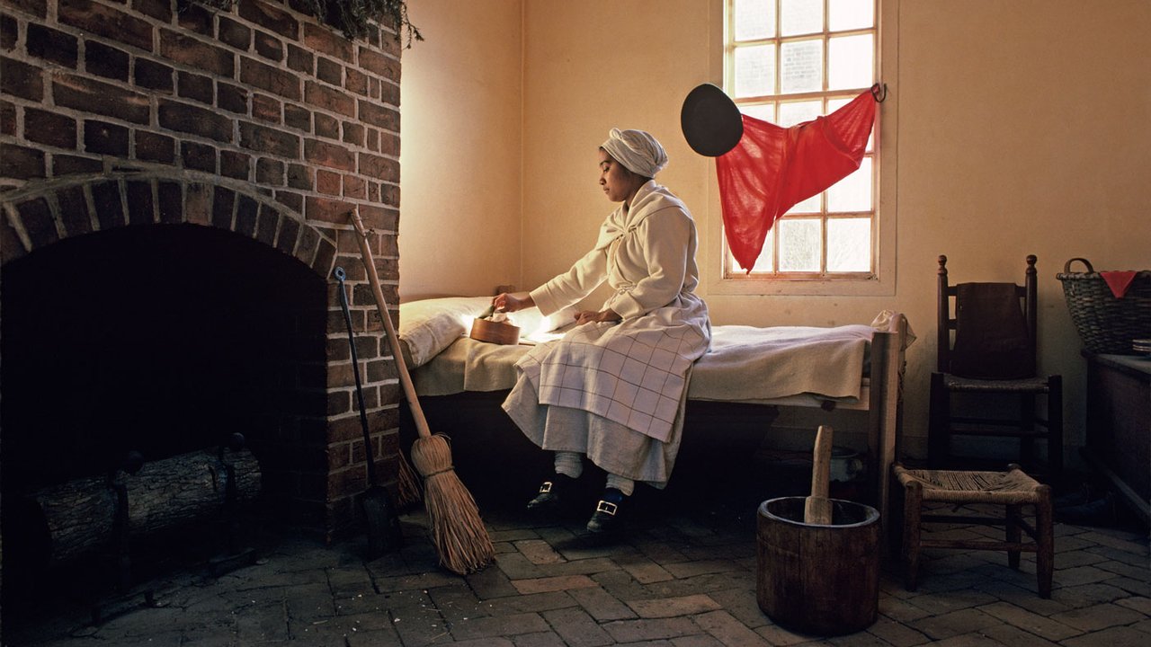 Actor-interpreter Brigitte Jackson in the quarters of the George Wythe kitchen.