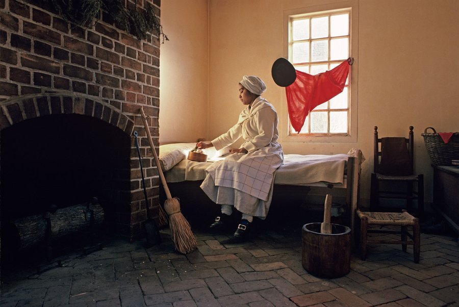 Actor-interpreter Brigitte Jackson in the quarters of the George Wythe kitchen.